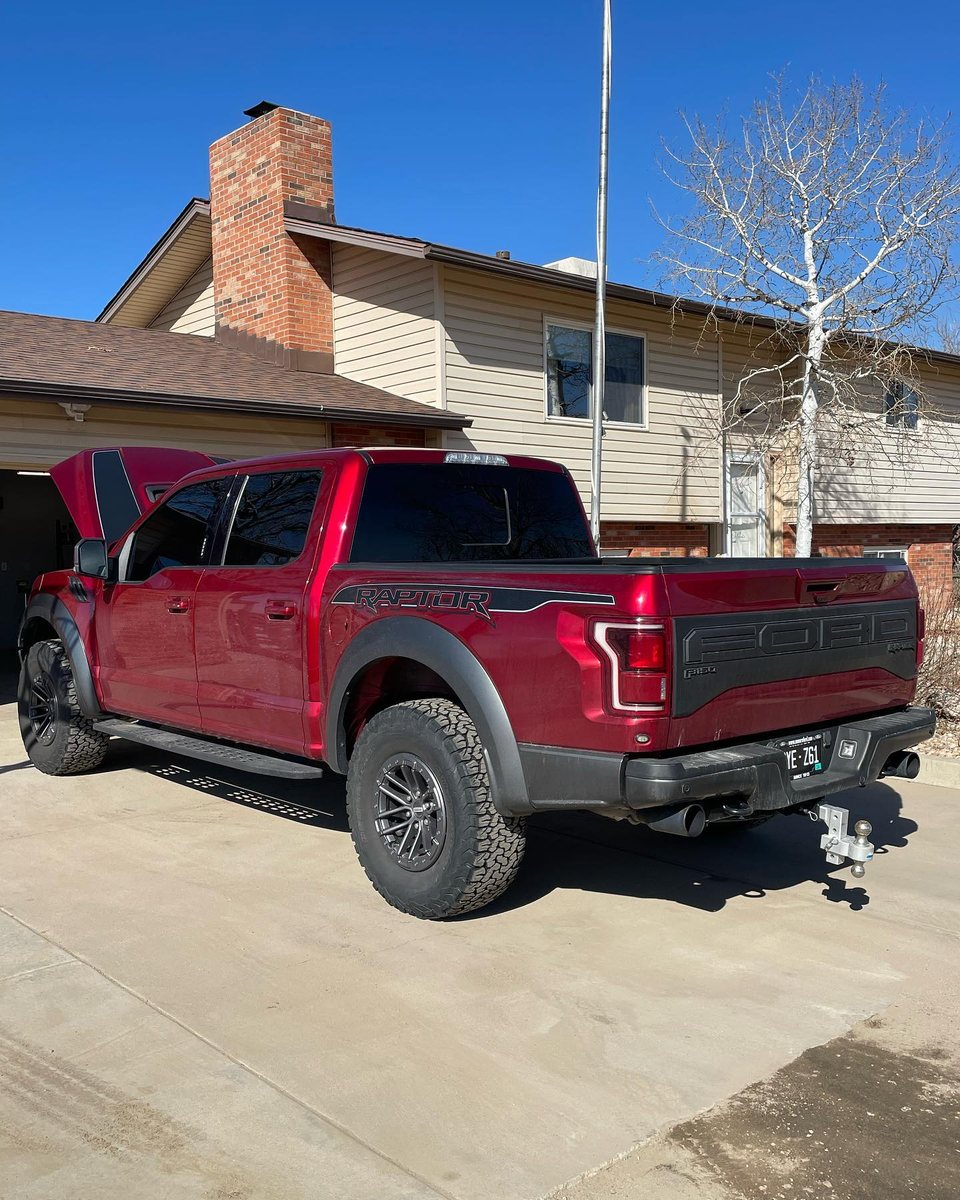 Red F-150 Raptor detailed in a customer's driveway